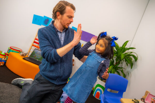 A high-five is often used as a positive reinforcement for kids.