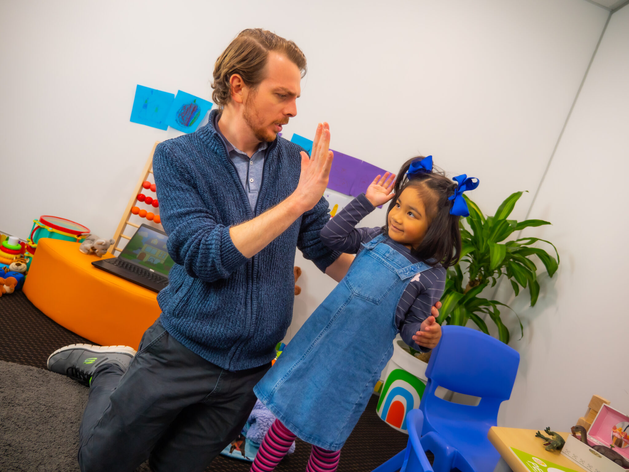 A high-five is often used as a positive reinforcement for kids.