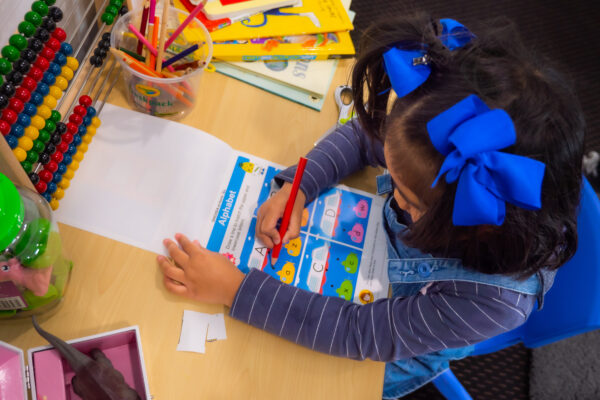A girls completing the workbook. Information retention